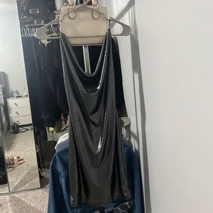 This is a dress from Madrag. It is grey with sparkles and has a open back.